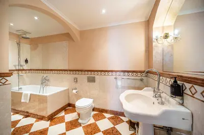 a bathroom with a sink and a tub and a toilet at Nosticova Heritage in Prague