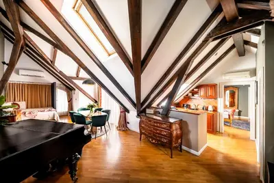 an attic room with a pool table and a kitchen at Nosticova Heritage in Prague