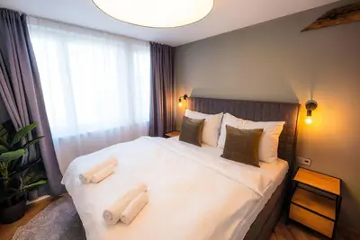 a bedroom with a large white bed with two pillows at 6BR Castle V!EWS A/C luxury Dolce Vita apartment in Prague