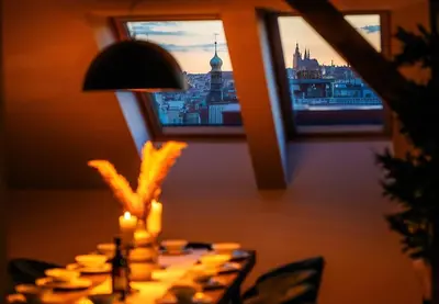 a table with a lamp and a view of a city at 6BR Castle V!EWS A/C luxury Dolce Vita apartment in Prague
