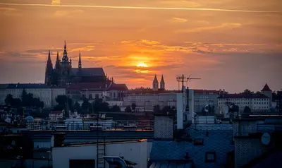 a view of a city with the sunset in the background at A/C LUX Rooftop APT 6BR+3.5Bath Wenceslas square in Prague