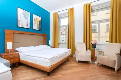 a bedroom with a bed and a blue wall at Moonlight Apartments Old Town in Prague