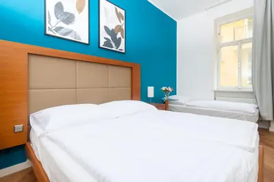 a bedroom with blue walls and a large bed at Moonlight Apartments Old Town in Prague