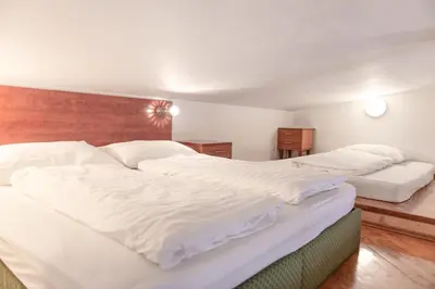 a bedroom with two beds with white sheets at Moonlight Apartments Old Town in Prague