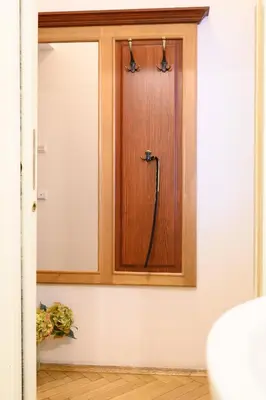 a room with a wooden cabinet with a door at Cosy central apartment in Žižkov in Prague