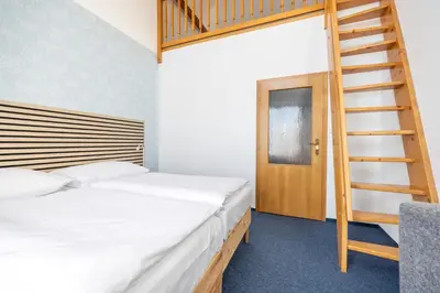 a bedroom with two beds and a bunk ladder at Marina Vltava in Nelahozeves
