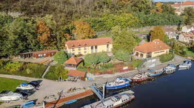 an aerial view of a house with boats in a marina at Marina Vltava in Nelahozeves