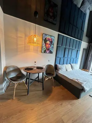 a room with a bed and a table and chairs at Appartment Pruhonice & terrace in Pruhonice