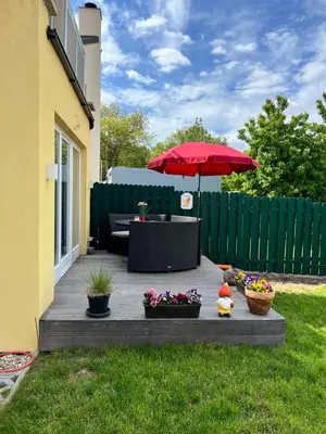 a patio with a table and a red umbrella at Appartment Pruhonice & terrace in Pruhonice