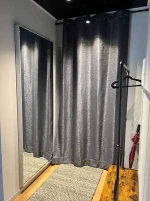 a black curtain in a room with a window at Appartment Pruhonice & terrace in Pruhonice