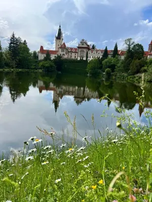 a castle reflected in the water of a lake at Appartment Pruhonice & terrace in Pruhonice