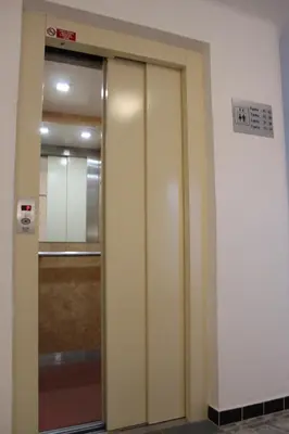 a elevator door in a building with a sign on it at Penzion Radost in Poděbrady