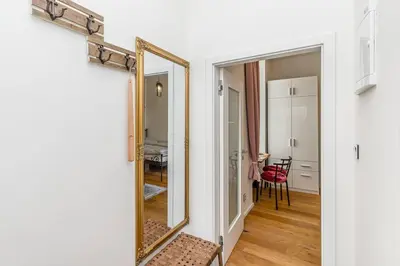 a mirror on a wall in a room at Cozy quiet new apartment in Karlin square in Prague