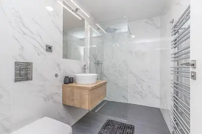 a white bathroom with a toilet and a sink at Cozy quiet new apartment in Karlin square in Prague