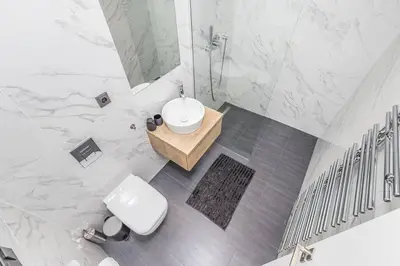 a white bathroom with a toilet and a sink at Cozy quiet new apartment in Karlin square in Prague