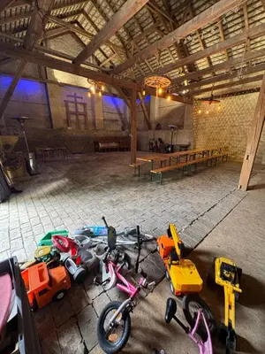 a group of bikes parked in a large room at Penzion pod Hazmburkem in Klapý