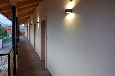 a hallway of a house with white walls and wooden floors at Penzion pod Hazmburkem in Klapý
