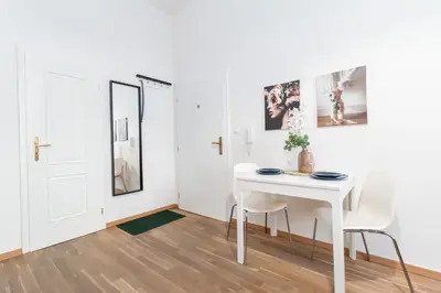 a room with a bed and a kitchen with a microwave at Stay Inn Apartments U Stundanky in Prague