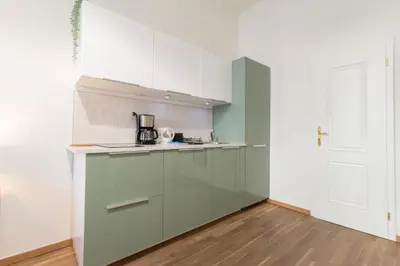 a small room with a bed and a microwave at Stay Inn Apartments U Stundanky in Prague