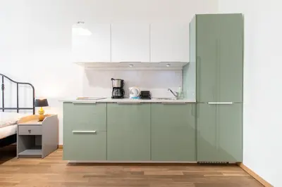 a bedroom with a bed and a table and chairs at Stay Inn Apartments U Stundanky in Prague