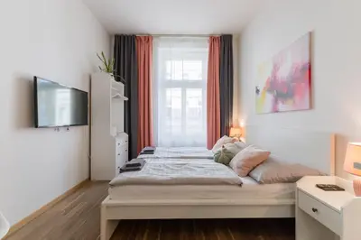 a kitchen with green and white cabinets and a door at Stay Inn Apartments U Stundanky in Prague