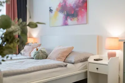 a kitchen and a living room with a couch at Stay Inn Apartments U Stundanky in Prague