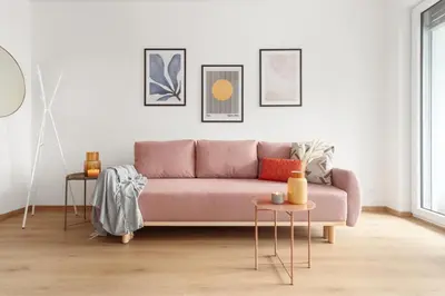 a living room with a pink couch and two tables at Prague Days - Studio with Balcony in quiet and trendy Holešovice in Prague