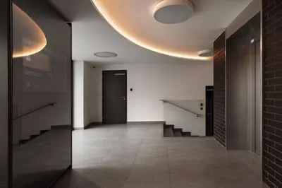 a hallway with stairs and a door and a ceiling at Prague Days - Studio with Balcony in quiet and trendy Holešovice in Prague