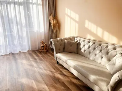 a living room with a couch and a wooden floor at Eva's Apartment Prague in Prague