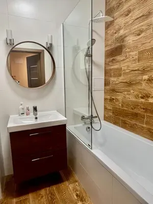 a bathroom with a sink and a shower with a mirror at Eva's Apartment Prague in Prague