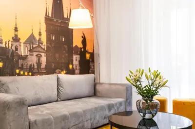 a living room with a couch and a table at A1 Royal Plaza in Prague