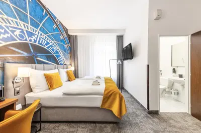 a hotel room with a bed and a bathroom at A1 Royal Plaza in Prague