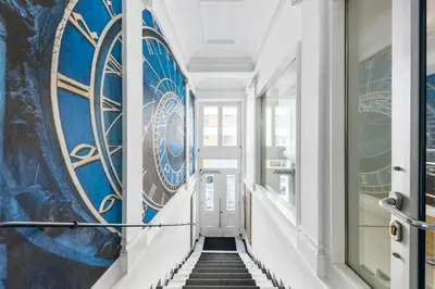 a hallway with blue and white walls and stairs at A1 Royal Plaza in Prague