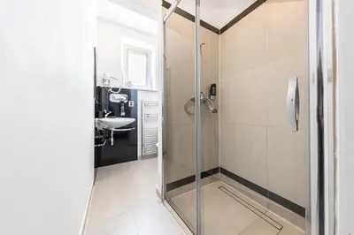 a bathroom with a shower and a sink at A1 Royal Plaza in Prague