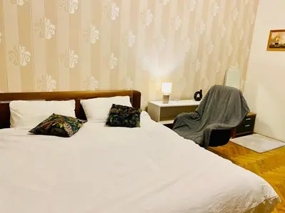 a bedroom with a bed with two pillows and a chair at aparthotel in Prague Centre in Prague