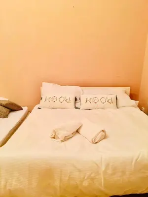 a bed with white sheets and pillows on it at aparthotel in Prague Centre in Prague