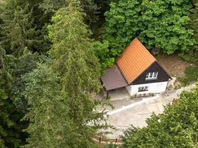 a small house is covered in snow at Holiday Home Zimořský domek by Interhome in Dolní Zimoř