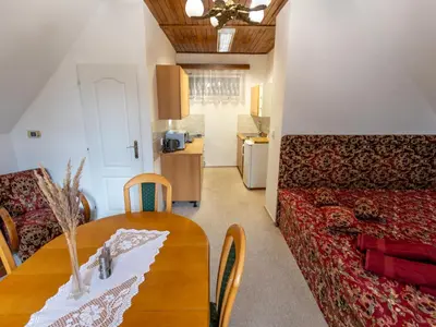 a patio with a table and chairs and a wooden ceiling at Holiday Home Zimořský domek by Interhome in Dolní Zimoř