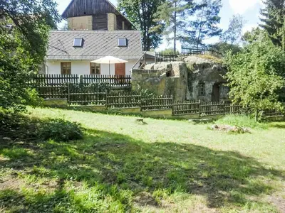 an old house with a fence in front of it at Holiday Home U skály by Interhome in Horní Vidim