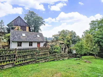an old house with a fence in a field at Holiday Home U skály by Interhome in Horní Vidim