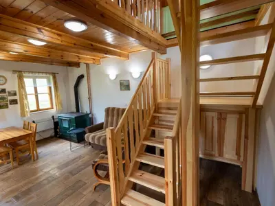 a staircase in a cabin with a living room at Holiday Home U skály by Interhome in Horní Vidim