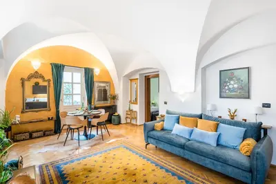 a living room with a blue couch and a table at Adam's Apartment - Best Location in Prague