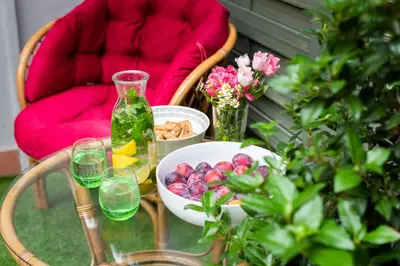 a glass table with a bowl of fruit and a vase at Adam's Apartment - Best Location in Prague