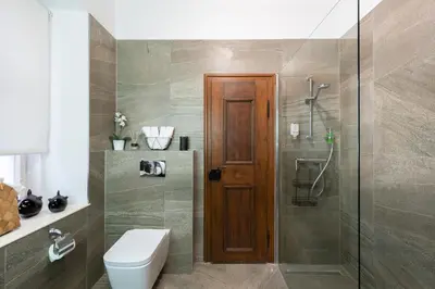 a bathroom with a toilet and a shower with a glass door at Adam's Apartment - Best Location in Prague