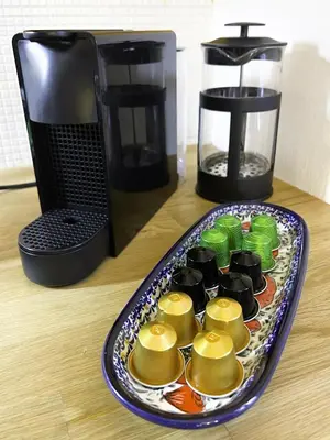 a plate of food on a table next to a coffee maker at Adam's Apartment - Best Location in Prague