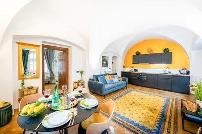 a living room with a table and a couch at Adam's Apartment - Best Location in Prague