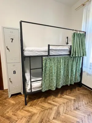 a bunk bed in a room with a wooden floor at Hostel DO-RE-MI in Prague
