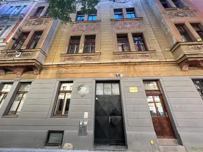 a building with doors and windows on a city street at Hostel DO-RE-MI in Prague
