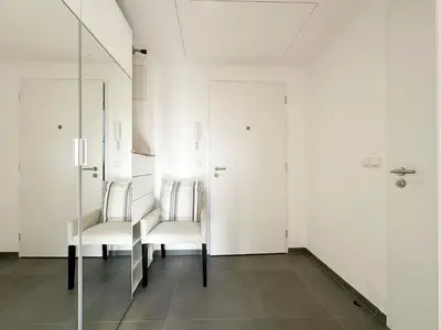 a white room with two chairs and a mirror at Vila Vinice in Prague
