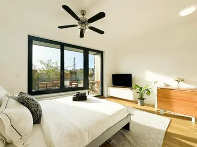 a bedroom with a bed and a ceiling fan at Vila Vinice in Prague